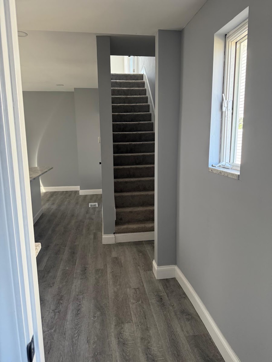 Renovated hallway with new flooring and staircase