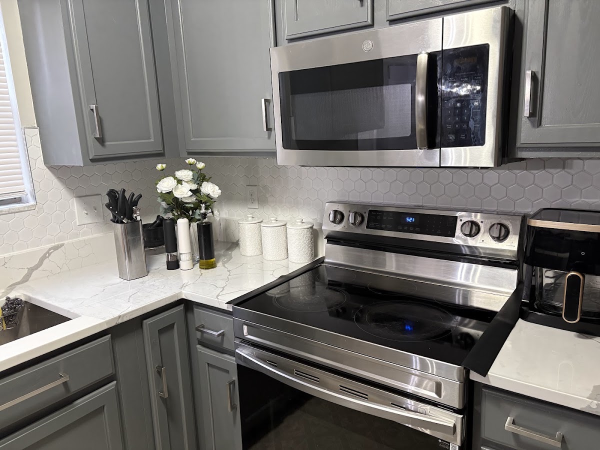 Kitchen after renovation, new gray cabinets and quartz countertop